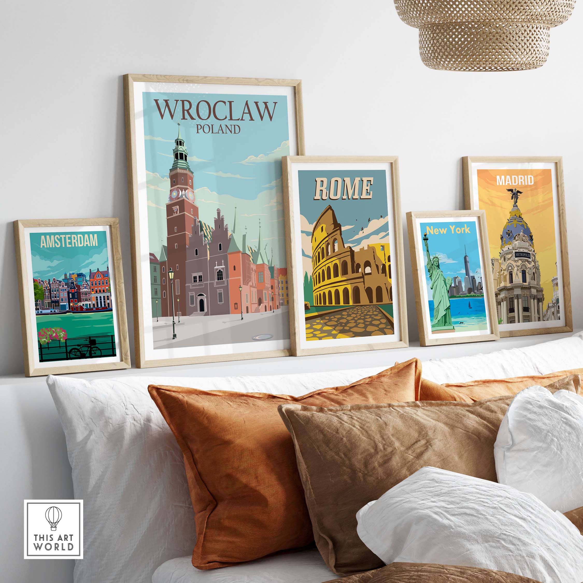 Wroclaw Poland poster among framed travel art prints of Amsterdam, Rome, New York, and Madrid on a stylish sofa.