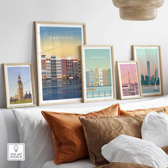 Framed Amsterdam wall art posters displayed above a cozy sofa, showcasing travel-inspired designs in a stylish living room.