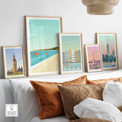 Collection of framed travel art prints featuring Aruba, London, Amsterdam, and Paris in a stylish home setting.