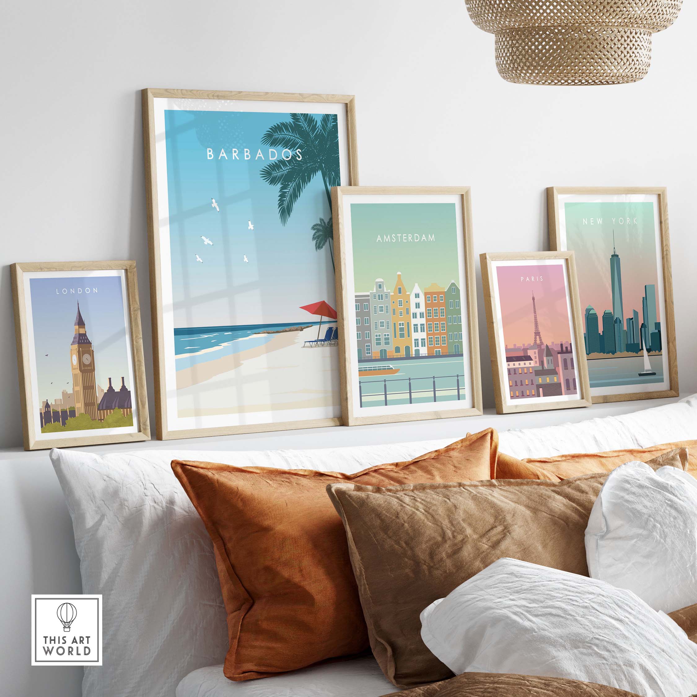 Barbados poster framed alongside city travel posters on a stylish sofa with decorative pillows.