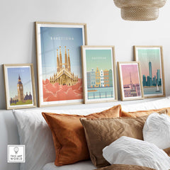 Barcelona Wall Art Poster Print displayed with framed travel posters of London, Amsterdam, and New York in a stylish living room.