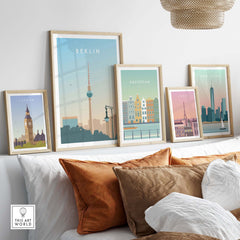 Berlin Print Wall Art Poster surrounded by other city prints on a stylish sofa with decorative cushions.
