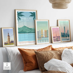 Kauai print wall art poster featuring Hanalei Bay along with framed vintage travel posters in a stylish home setting.
