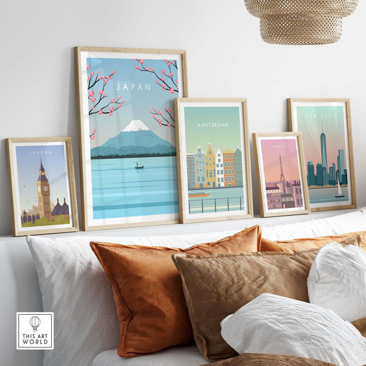 Colorful wall art featuring Mount Fuji and travel posters of London, Amsterdam, Paris, and New York on a sofa.