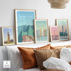 Machu Picchu print wall art poster alongside framed travel posters of London, Amsterdam, and New York on a stylish sofa.