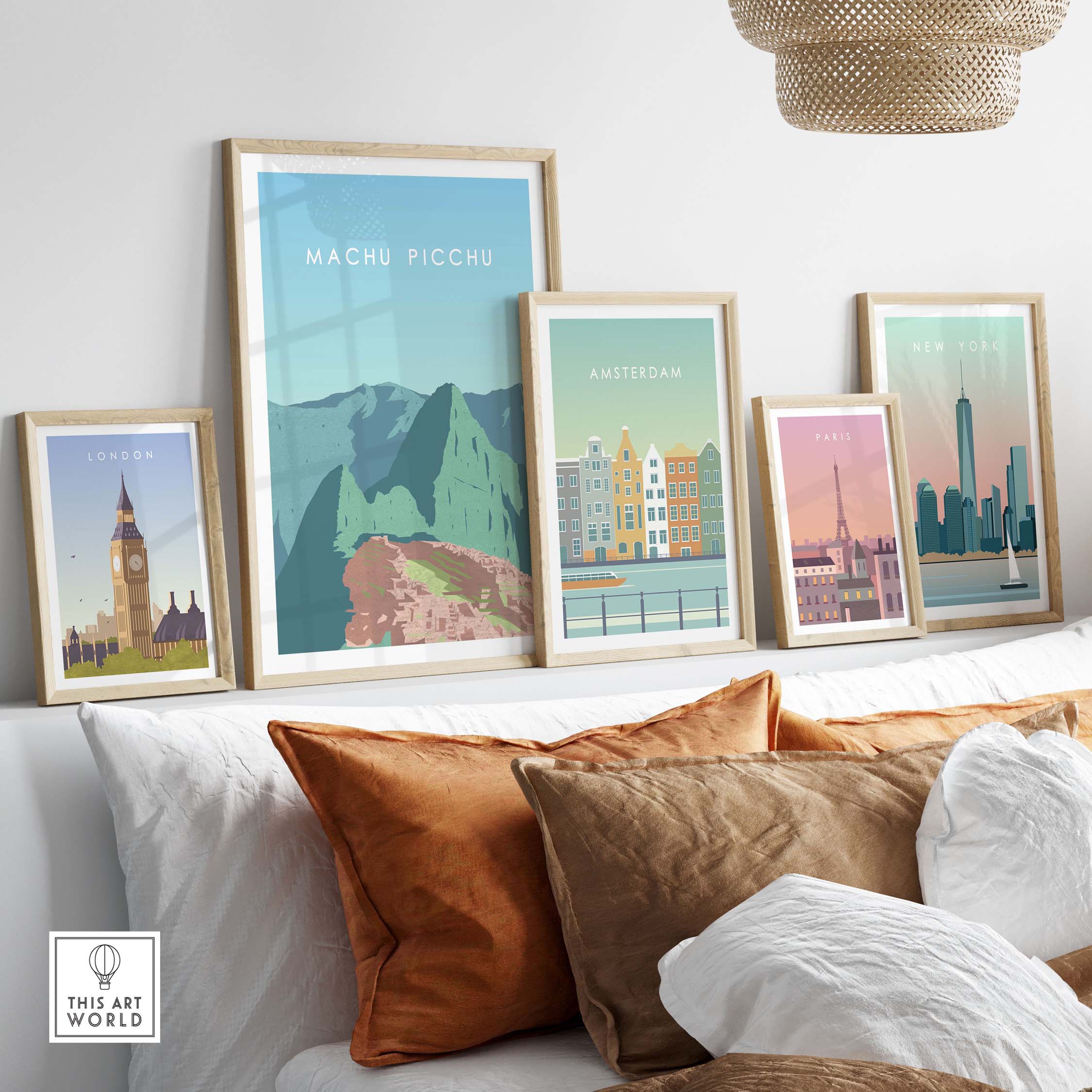 Machu Picchu print wall art poster alongside framed travel posters of London, Amsterdam, and New York on a stylish sofa.