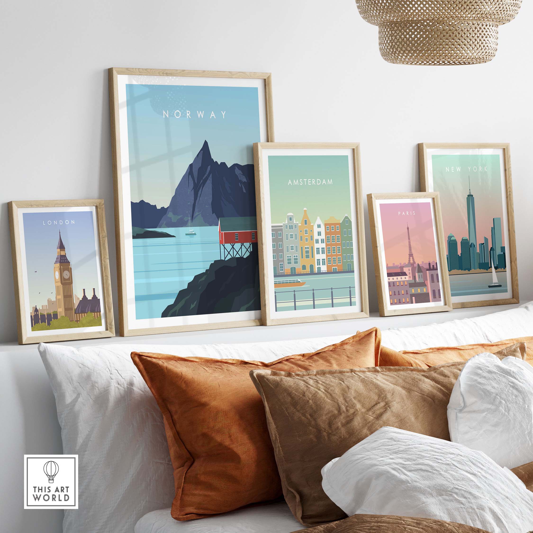 Framed Norway print wall art among other city posters on a stylish sofa with cushions.
