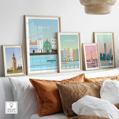 Framed Poole Print Poster and other travel wall art decor on display above stylish cushions.