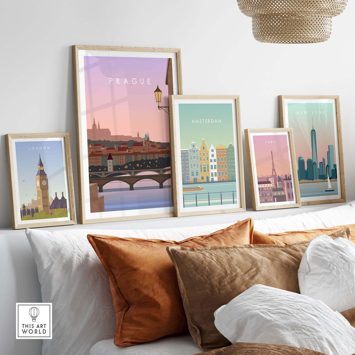 Framed travel wall art featuring iconic city prints of London, Amsterdam, New York, and Prague in a cozy living room setting.