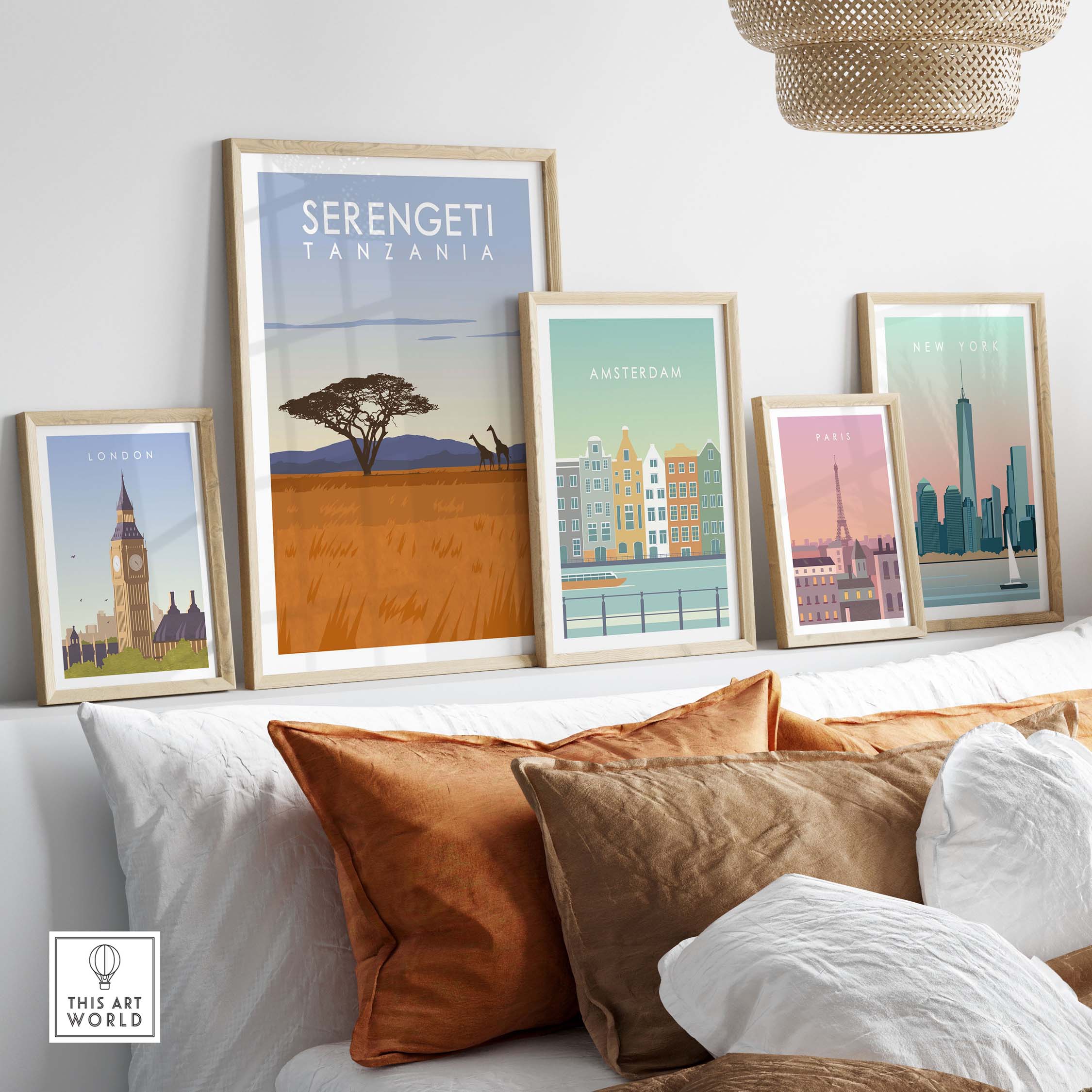 Framed Serengeti Print Tanzania Travel Poster among other city posters on a stylish sofa.