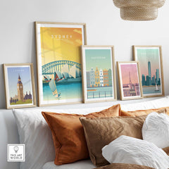 Sydney travel poster print alongside other city posters in a cozy home decor setting with stylish cushions.