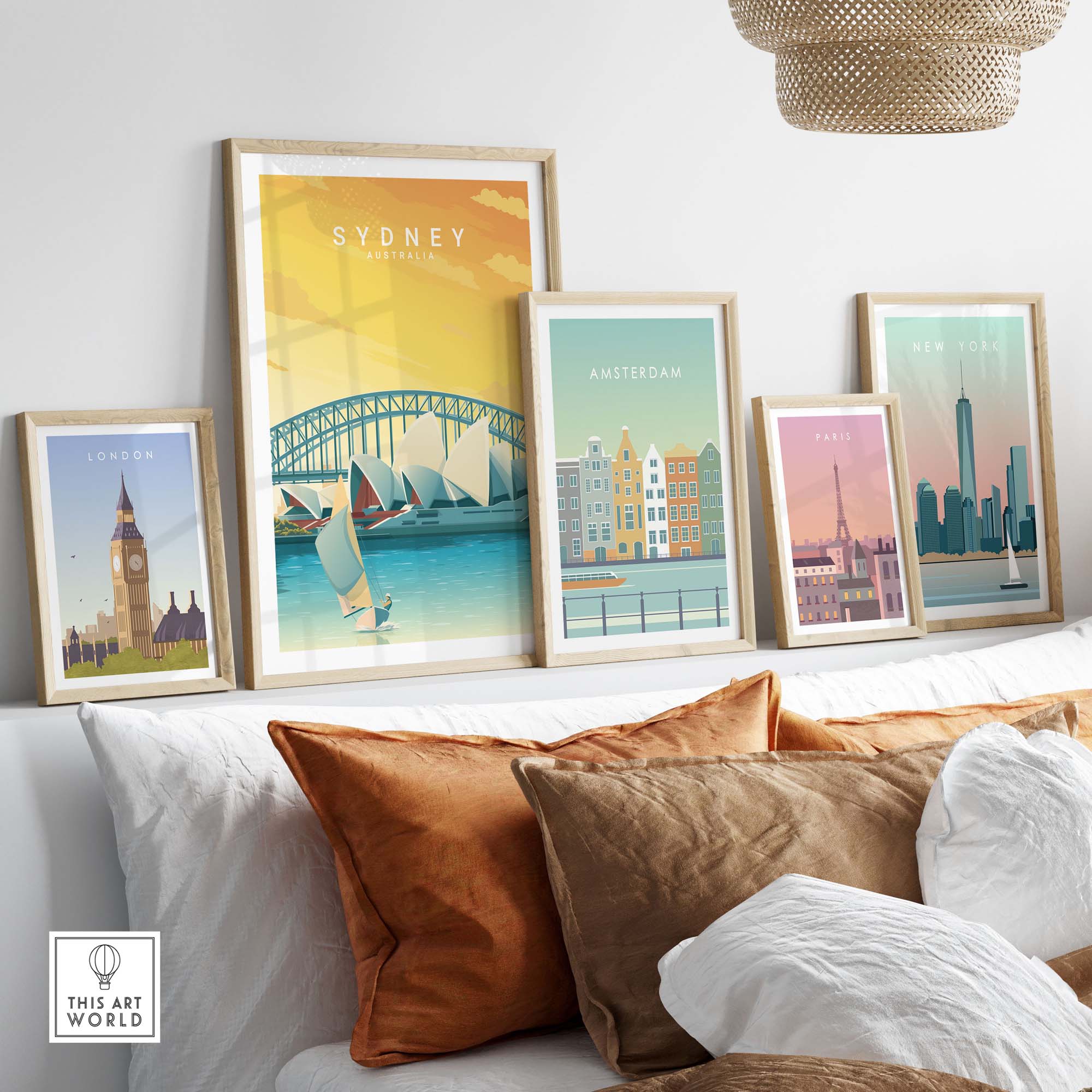 Sydney travel poster print alongside other city posters in a cozy home decor setting with stylish cushions.