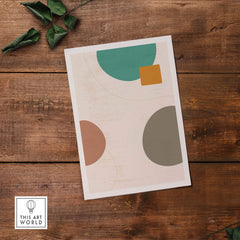 Abstract digital print featuring circular and geometric shapes in earthy tones on a rustic wooden background.
