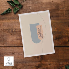 Boho art print featuring abstract shapes and a leaf design, perfect for modern nursery decor.