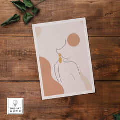 Abstract female outline print featuring modern line drawing on rustic wooden background.