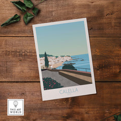Costa Brava Calella Spain vintage travel poster on wooden table with greenery.