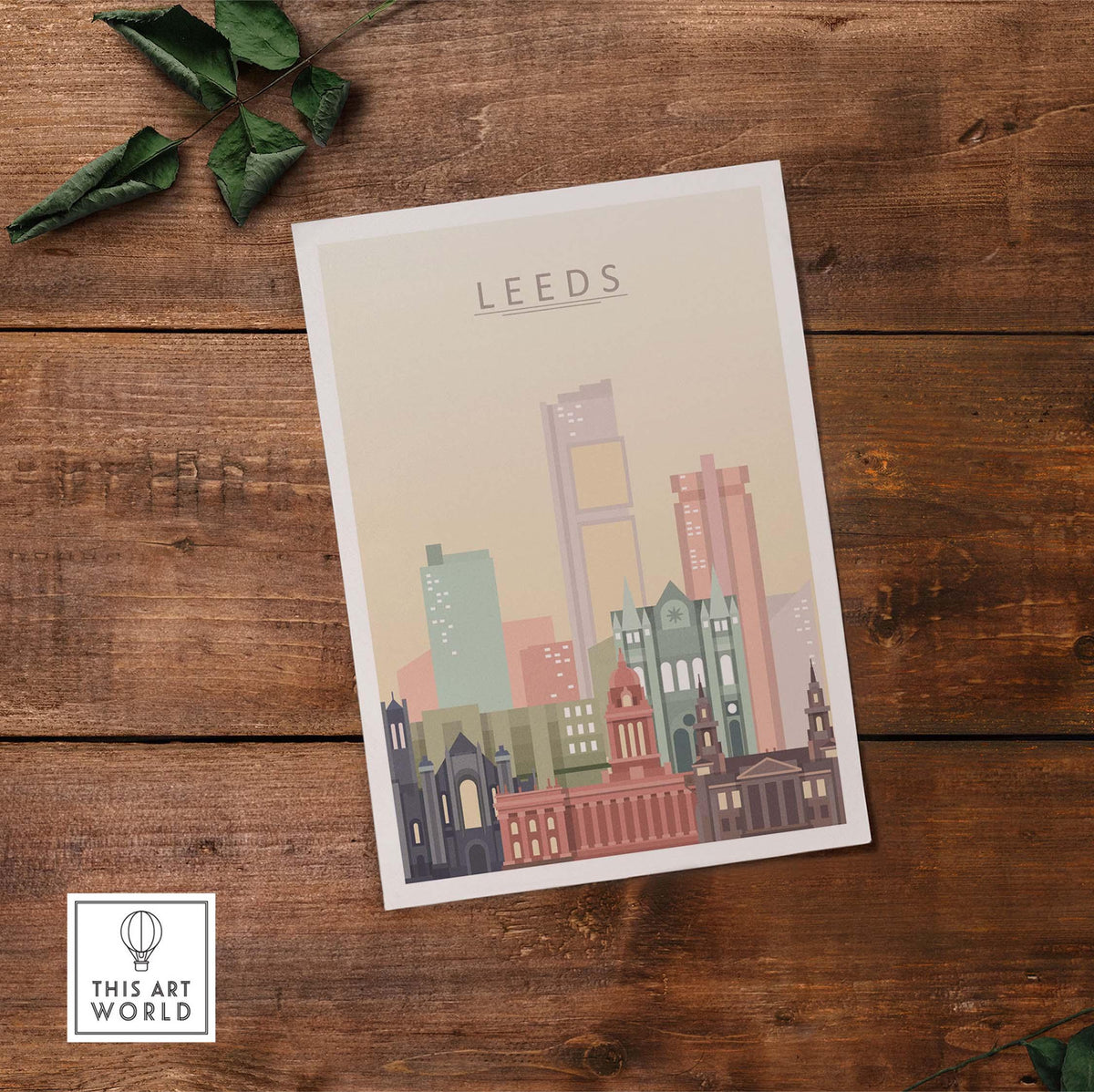 Leeds Print Skyline Wall Art featuring iconic buildings in warm pastel tones on a wooden surface.