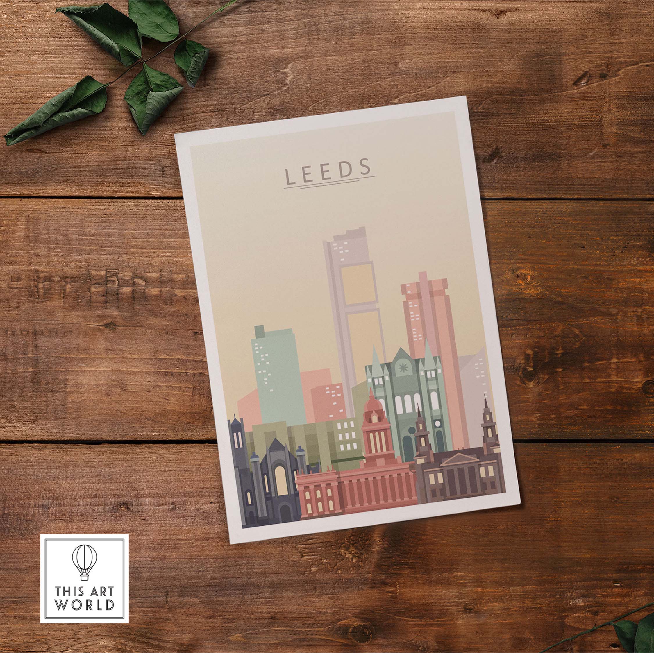 Leeds Print Skyline Wall Art featuring iconic buildings in warm pastel tones on a wooden surface.