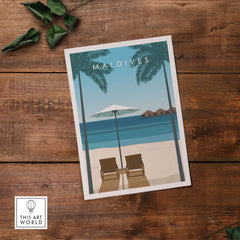 Maldives travel poster featuring a serene beach scene with lounge chairs and an umbrella, ideal for home or office decor.