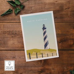 North Carolina travel poster print featuring a striped lighthouse and minimalist design on wooden background.