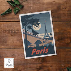 Vintage-inspired Paris poster print featuring the Eiffel Tower and moonlit scene on rustic wood background.