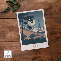Moonlit Paris France travel poster featuring the Eiffel Tower and a vintage-inspired design on wooden background.