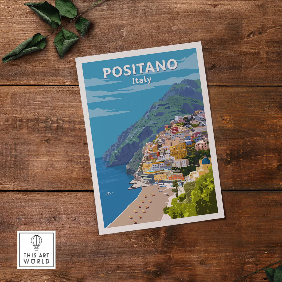Positano poster print Italy wall art showcasing vibrant coastal village and beach on a wooden surface.