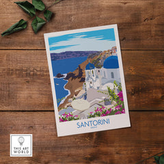 Santorini print travel poster showcasing the iconic blue-domed buildings and coastal views of Greece on a wooden background.
