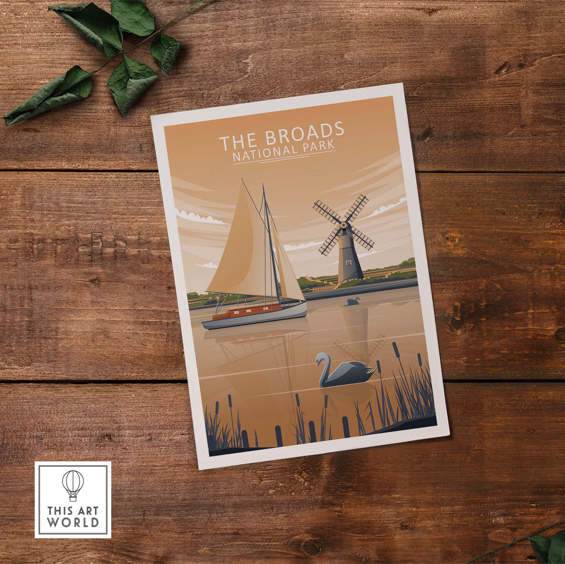 The Broads National Park poster featuring a sailboat and windmill design, presented on rustic wooden background.