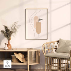 Abstract palm leaf print framed above a stylish wooden table in a modern living space.