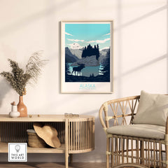 Alaska print travel poster framed on wall above rattan furniture in stylish modern interior decor.