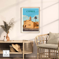 Cyprus vintage travel print in a minimalist frame on a wall, showcasing a historical building and palm trees.