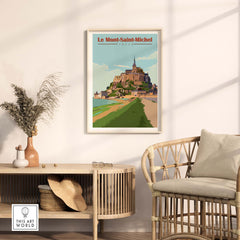Le Mont Saint Michel poster print displayed in a stylish living room with natural decor and warm lighting.