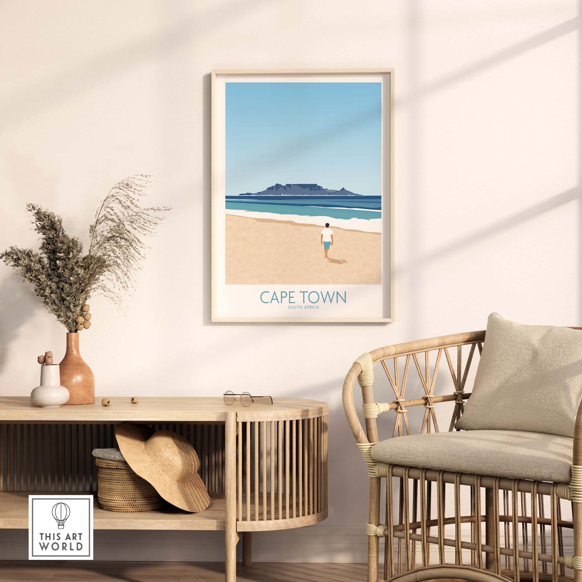 Cape Town wall art print displayed in a stylish interior with a rattan chair and beach scene in minimalistic design.