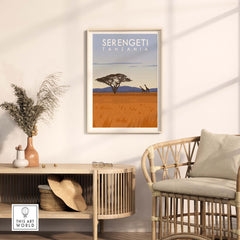 Serengeti Print Tanzania travel poster displayed in a stylish living room with a cozy chair and decorative elements.