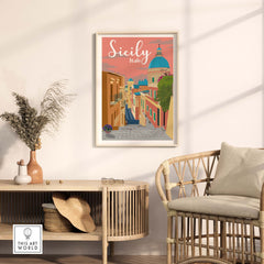 Sicily Print Italy Poster displayed in a stylish living room with a rattan chair and green plants.